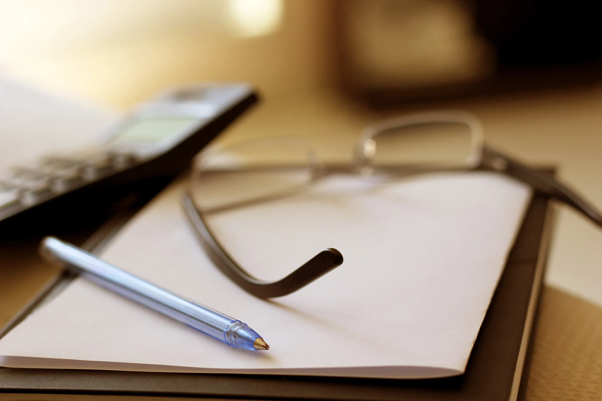 Privacy policy — glasses and a pen on a notebook